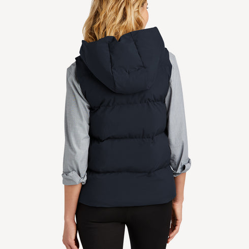 Back view of women’s navy waterproof puffer vest on model – Louvóre apparel